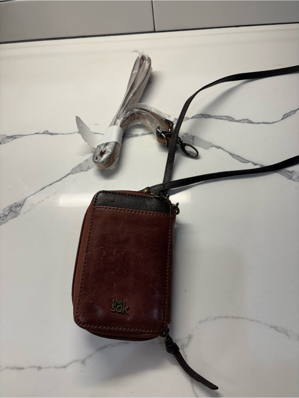 The Sak Brown Leather Crossbody Wallet with Black Trim